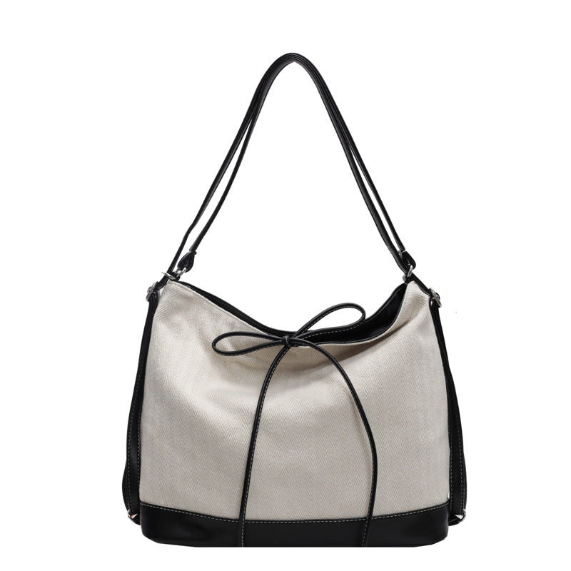 krémfekete átalakítható női vászon válltáska elölnézetben masnis húzózsinórral