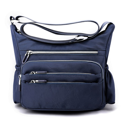 Dollcini sötétkék nylon hobo válltáska, több cipzáras elülső zsebbel