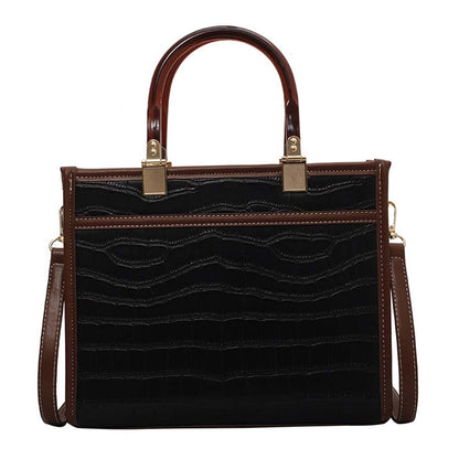 fekete krokodilhatású női műbőr crossbody táska elölnézetben barna fogantyúval